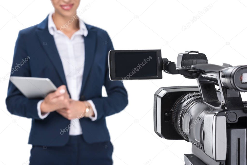 newscaster standing in front of camera