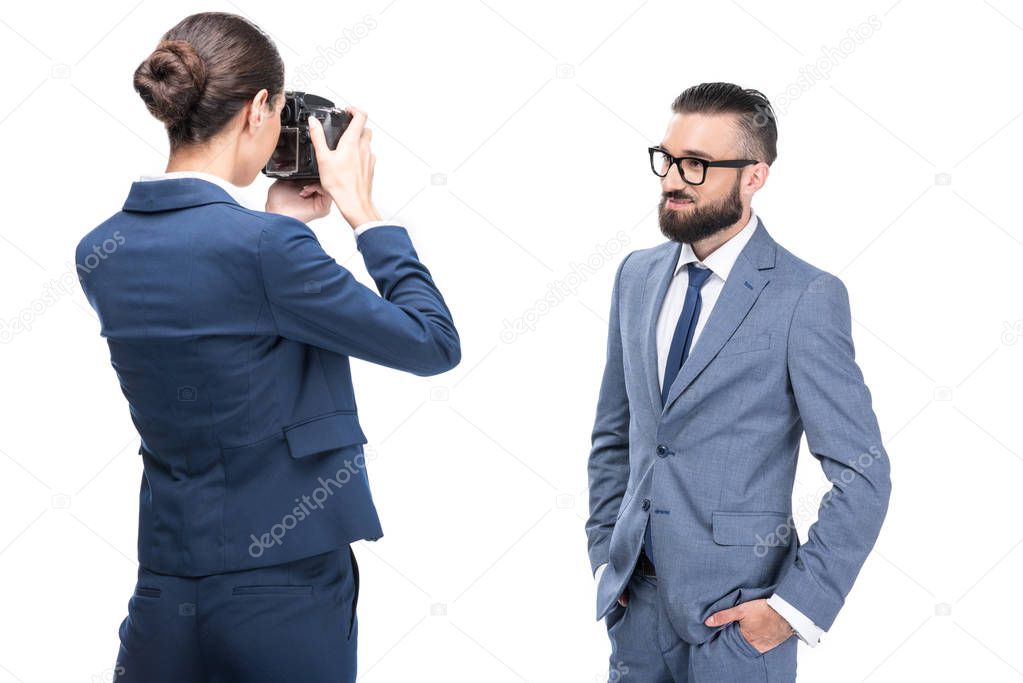 woman taking photo of businessman