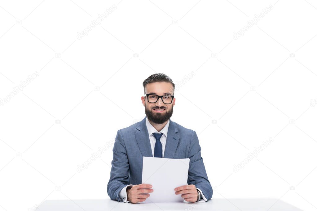 smiling newscaster with papers