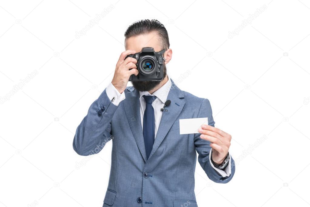 businessman taking photo of card