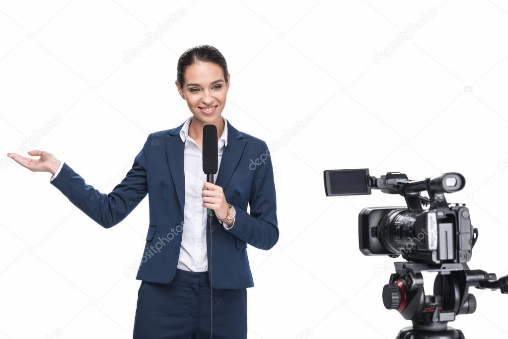 journalist with microphone looking at camera
