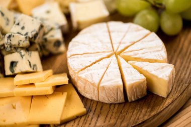 various cheese types and grapes clipart