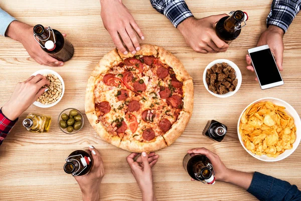 Vänner äta pizza tillsammans — Stockfoto