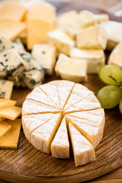 various cheese types and grapes