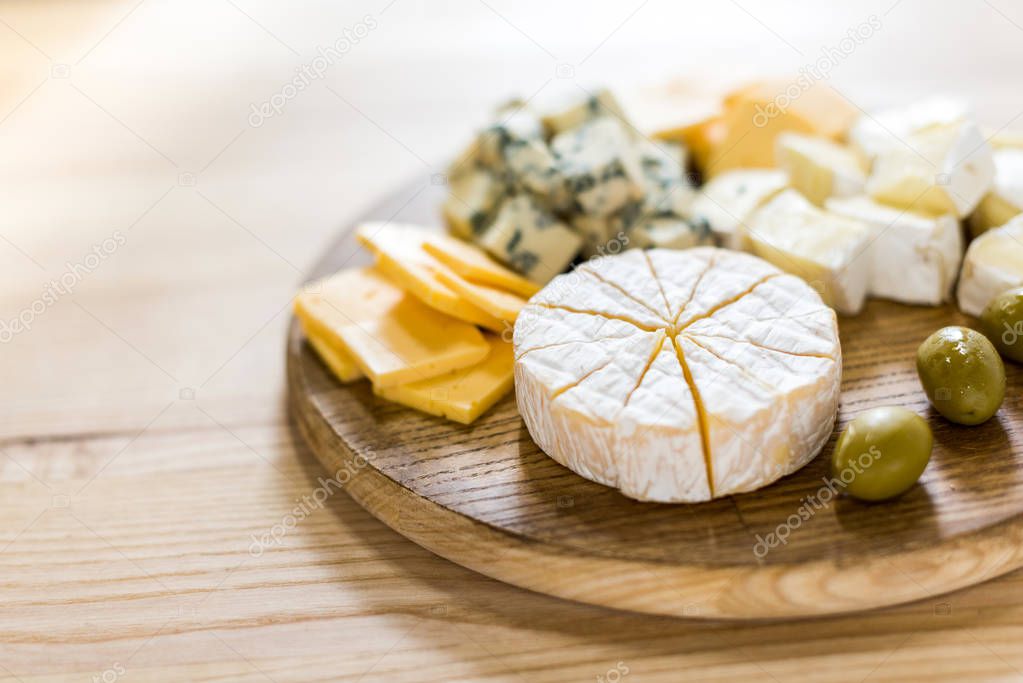 various cheese types and olives