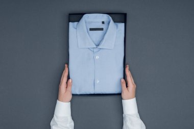 tailor with shirt in box clipart