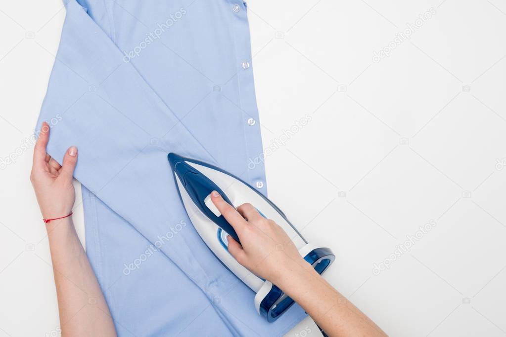 woman ironing shirt