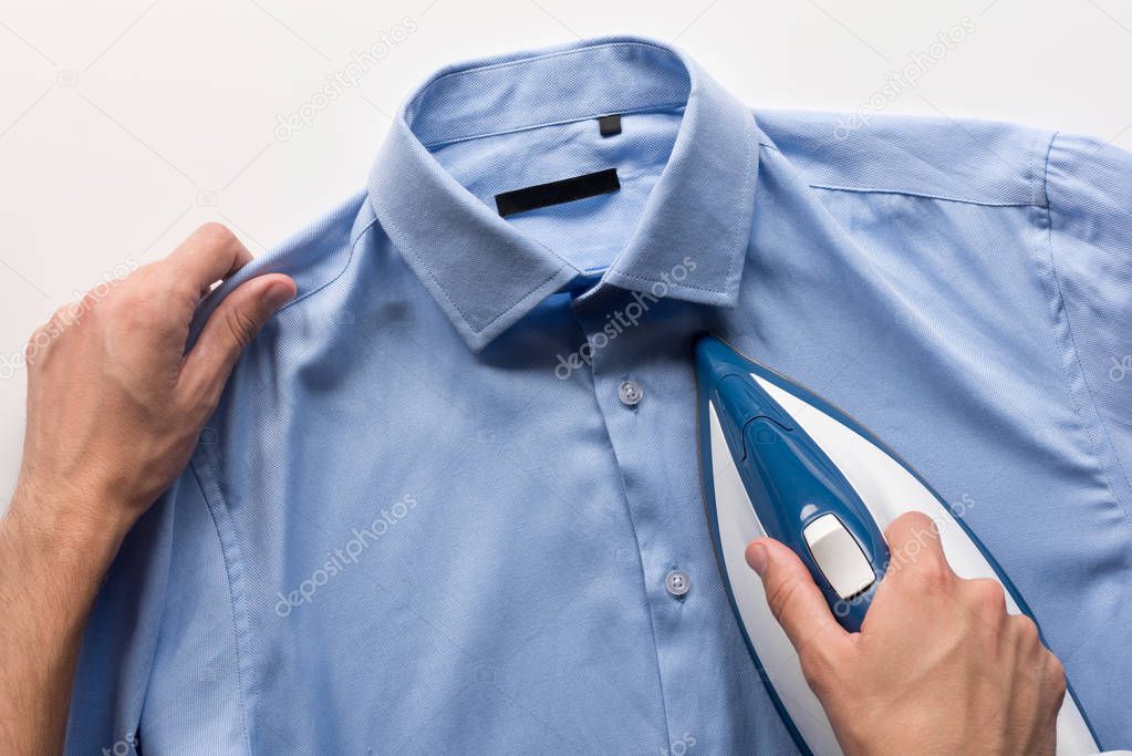 man ironing shirt