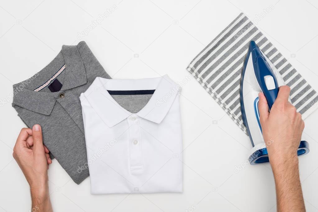 man ironing clothes