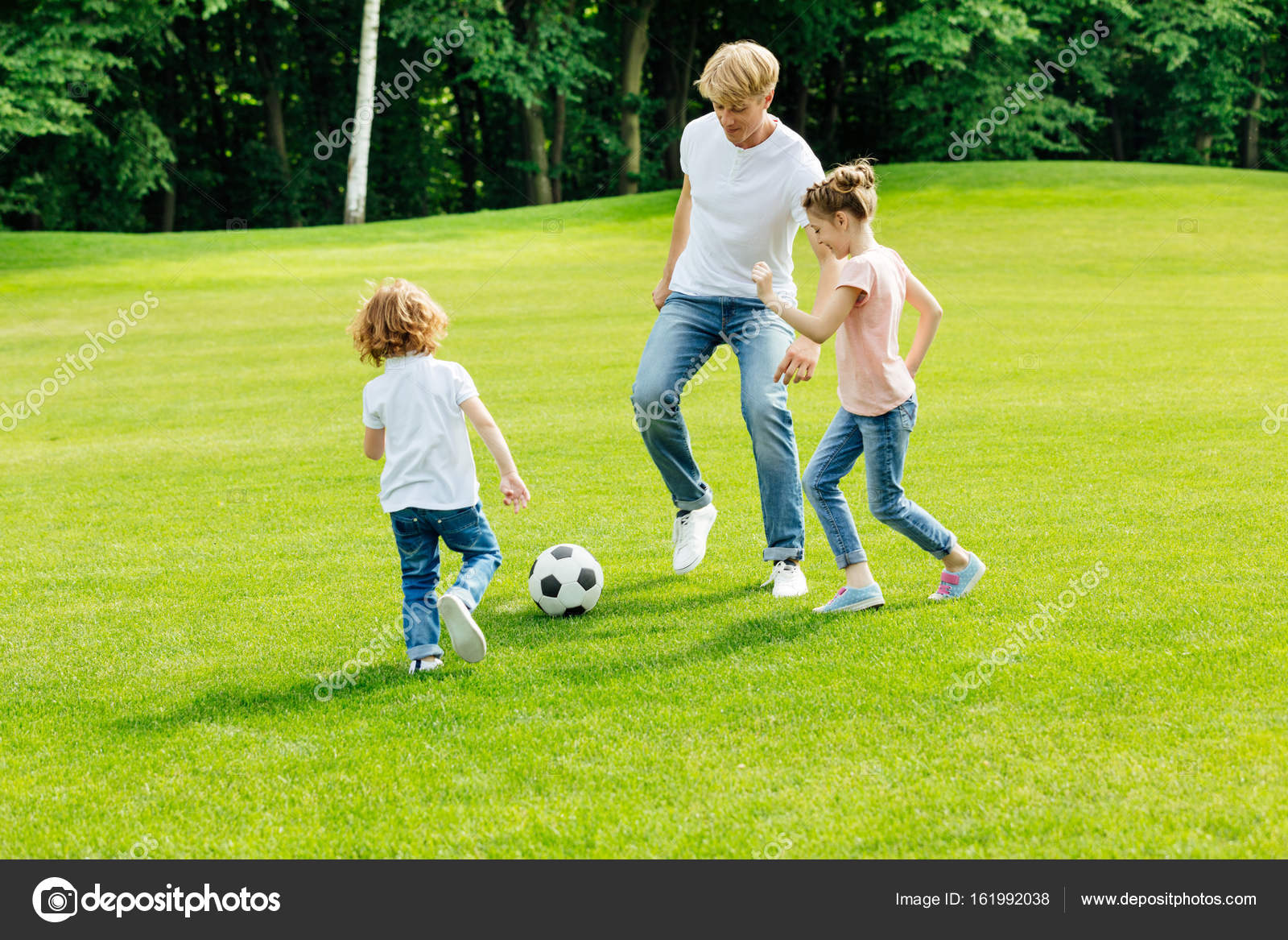 Father With Kids Playing Soccer In Park Stock Photo Image By C Allaserebrina
