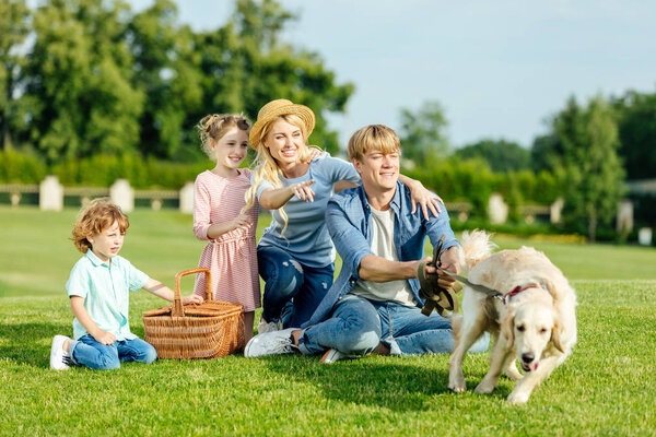 family with dog at picnic 
