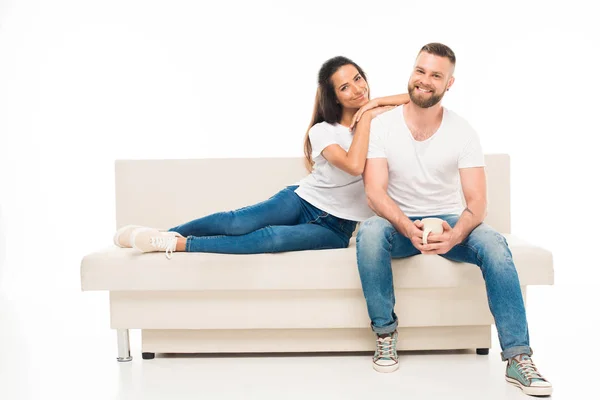 Young attractive couple on couch — Stock Photo, Image