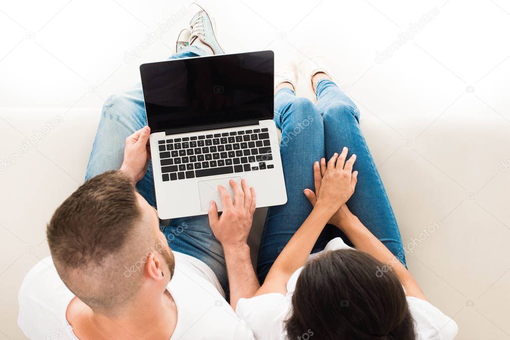 young couple using laptop