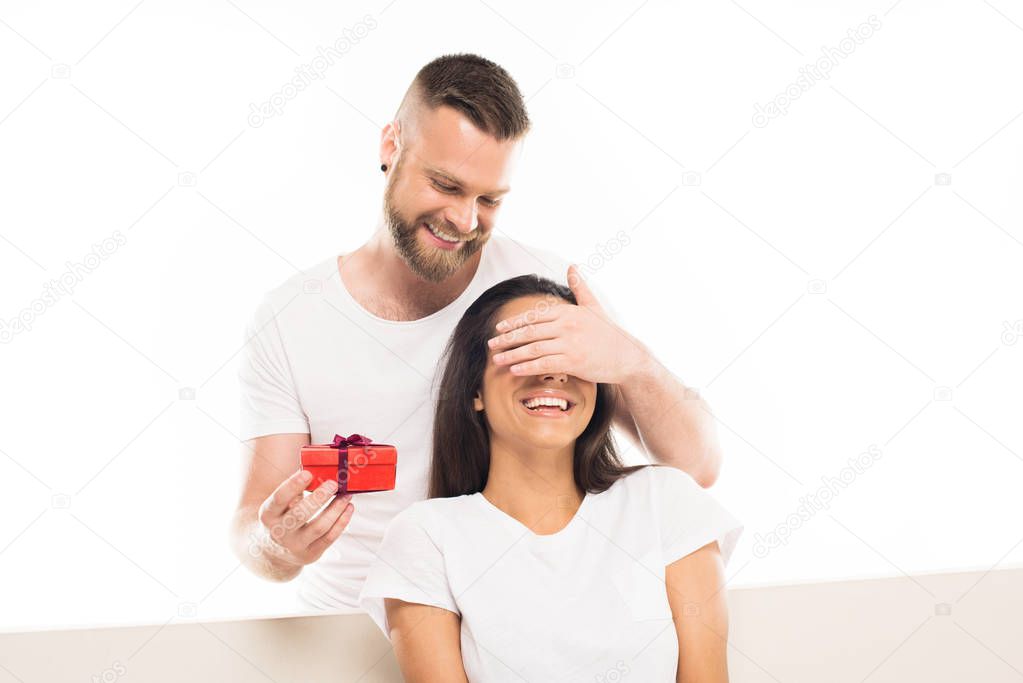 man surprising girlfriend by gift