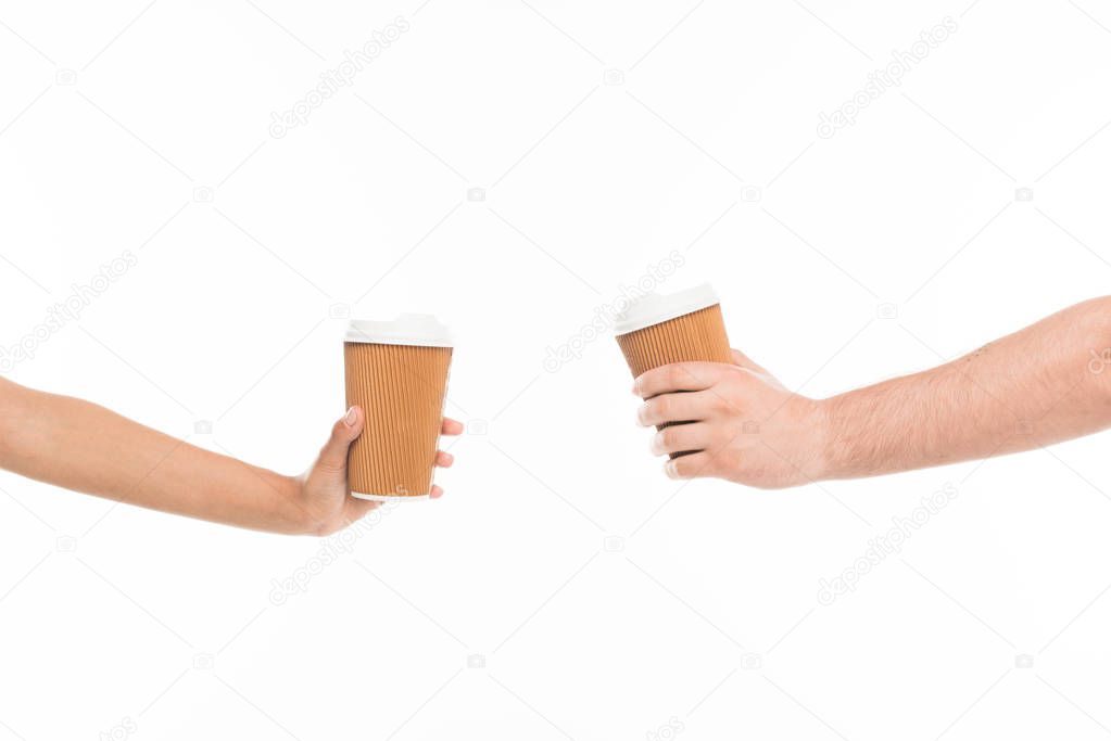 hands holding disposable cups