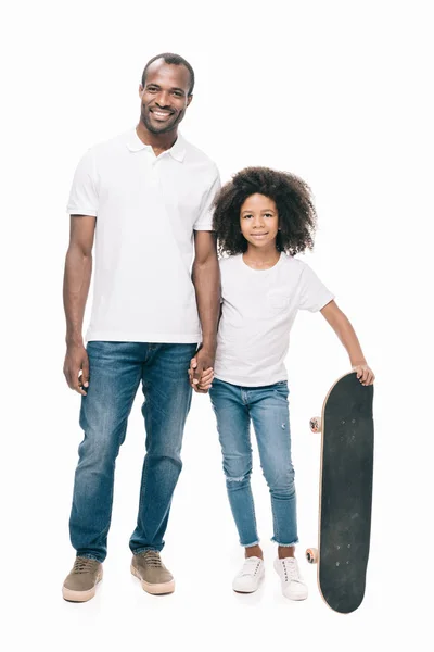 Happy father and daughter with skateboard — Stock Photo, Image