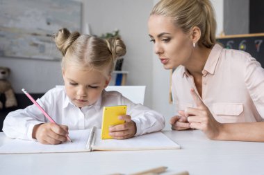 mother and daughter learning mathematics clipart