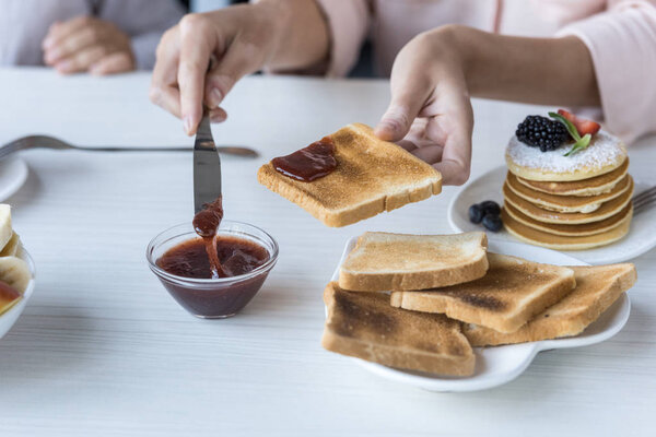 mother and daughter having breakfast