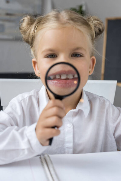 child with magnifier