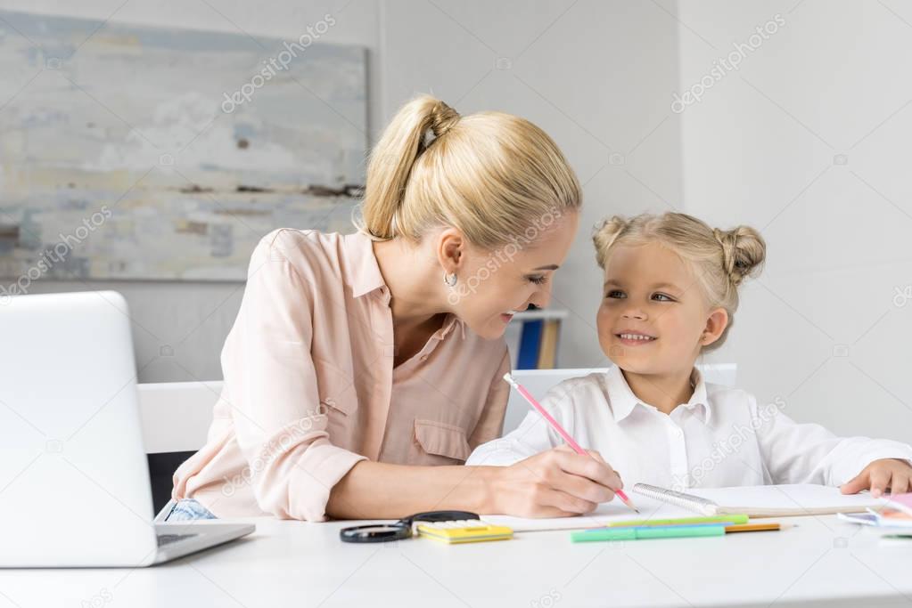 mother and daughter drawing together