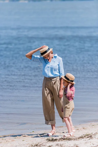 Mother and daughter walking at seashore — Free Stock Photo