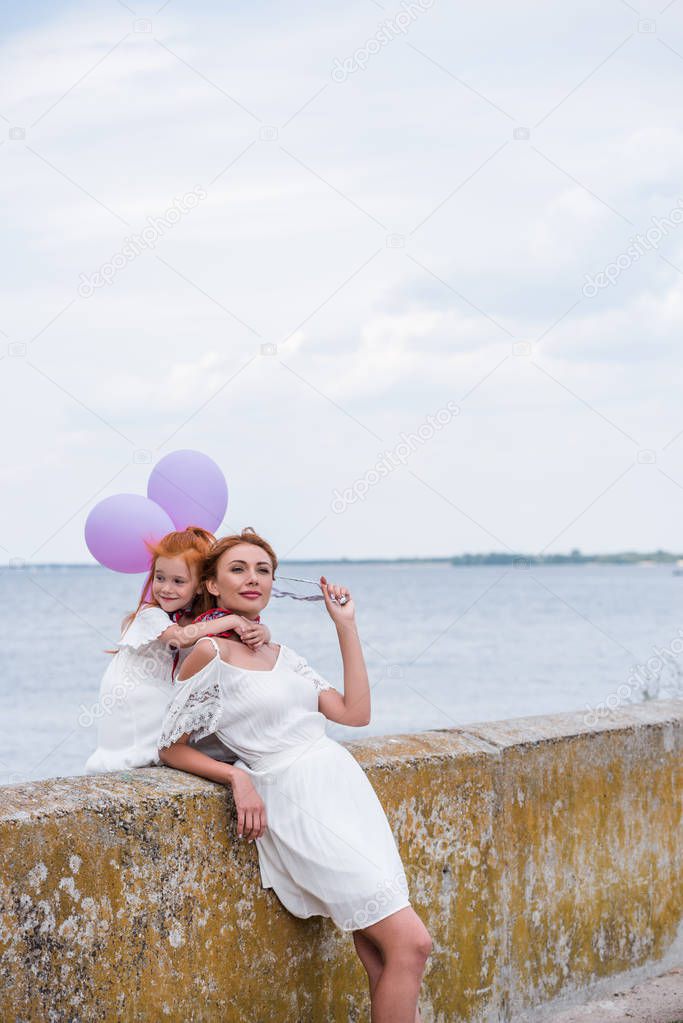 mother and daughter with balloons 