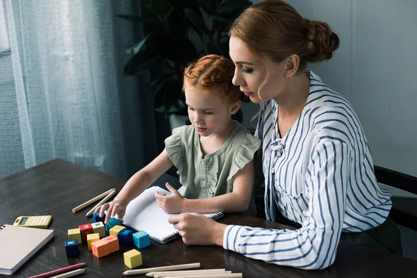 Mother and daughter learning at home — Stock Photo, Image