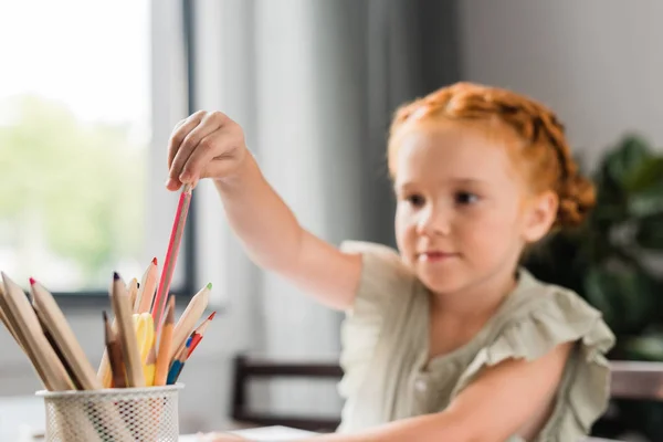 Girl choosing color pencil — Stock Photo, Image