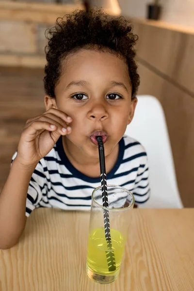 African american child drinking juice — Free Stock Photo