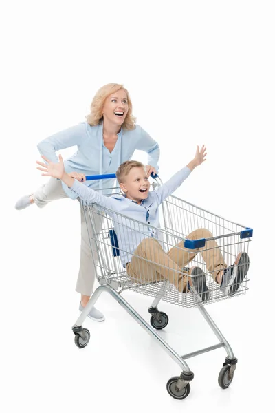 Moeder rijden zoon in winkelwagen — Stockfoto