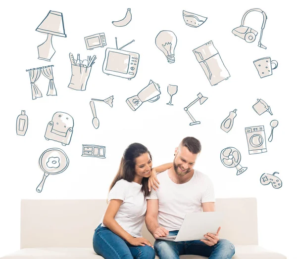 Attractive couple using laptop — Stock Photo, Image