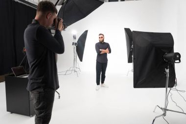 photographer working in studio with model clipart