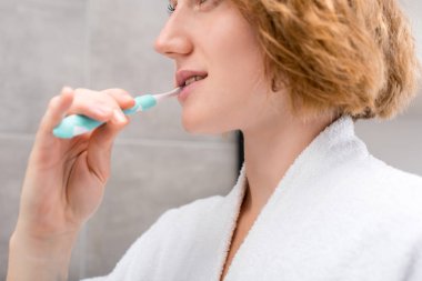 woman brushing teeth clipart