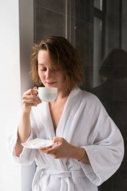 girl in bathrobe drinking coffee clipart
