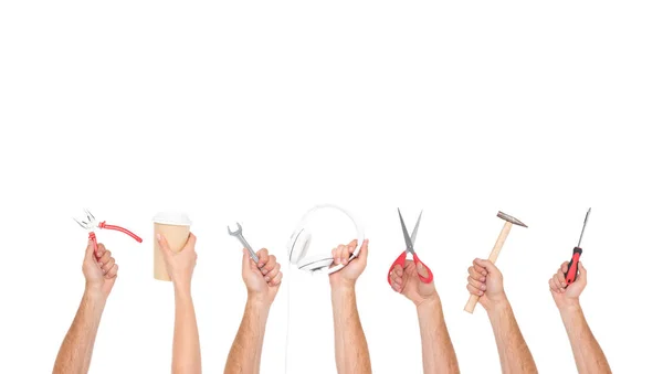 Hands holding tools and objects — Stock Photo, Image