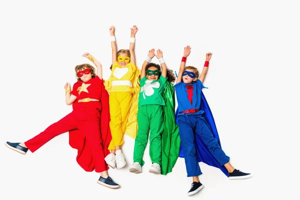 Flying kids in superhero costumes — Stock Photo, Image