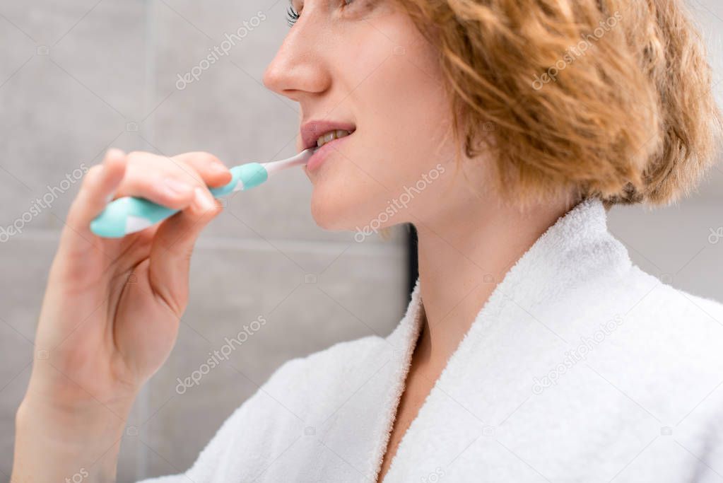 woman brushing teeth