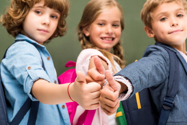 schoolchildren showing thumbs up