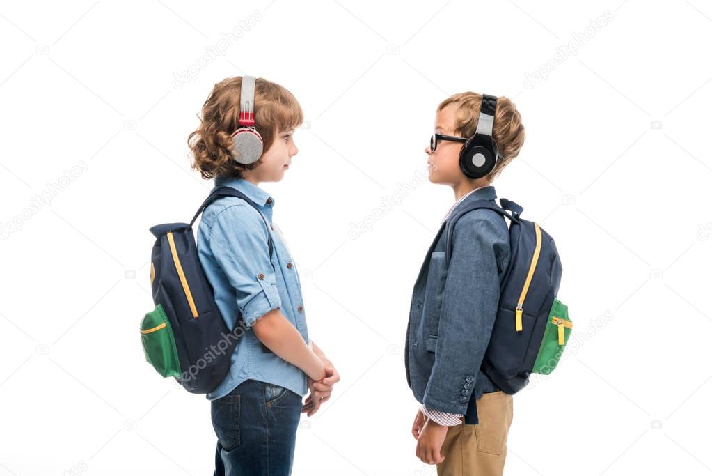 schoolboys with backpacks and headphones