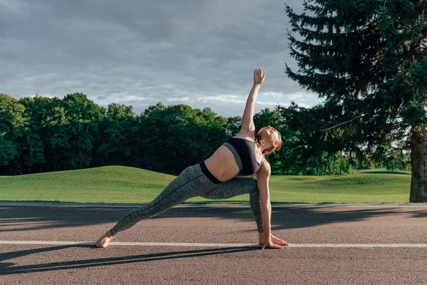 Caucasian woman practicing yoga pose — Free Stock Photo