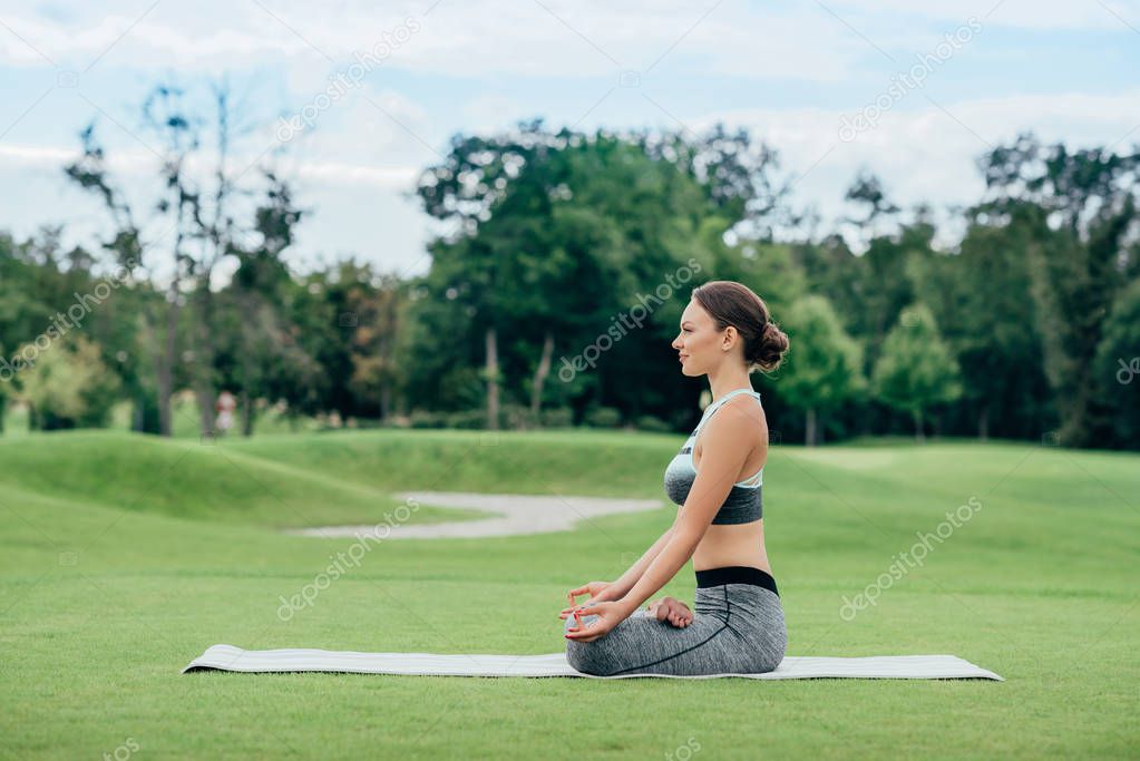 relaxed woman practicing lotus pose