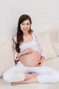 Pregnant woman touching her belly   clipart