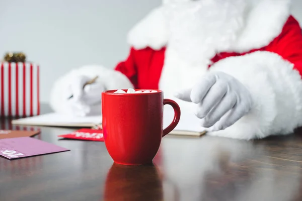 Santa drinking hot chocolate with marshmallows — Stock Photo, Image