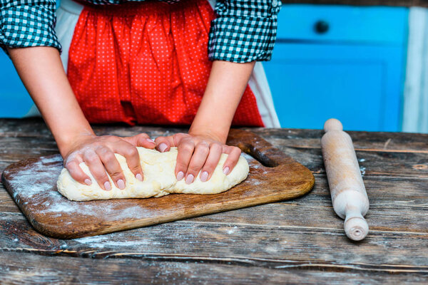 woman kneading dough
