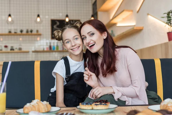 Ibu dan anak di kafe dengan makanan penutup — Stok Foto