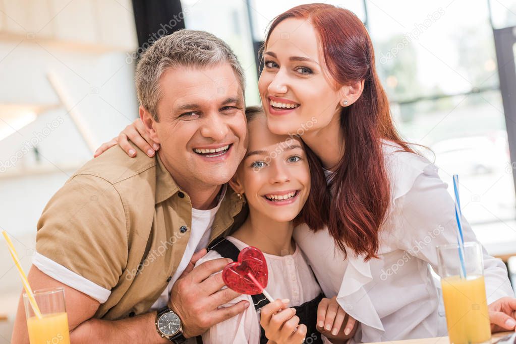 couple and teen daughter in cafe