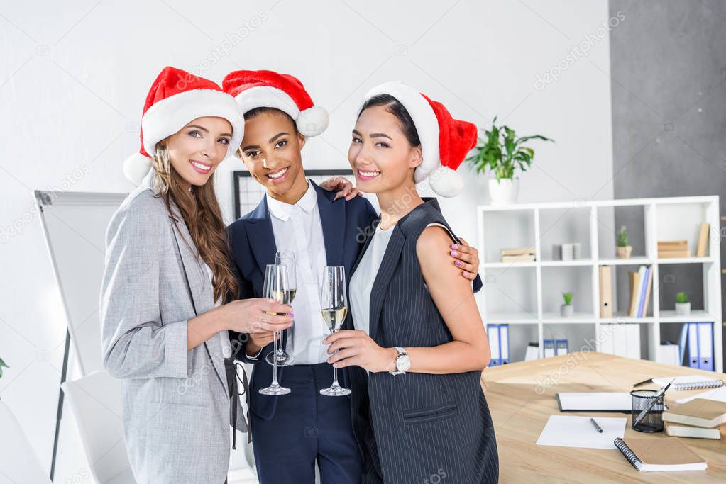 businesswomen drinking champagne in office