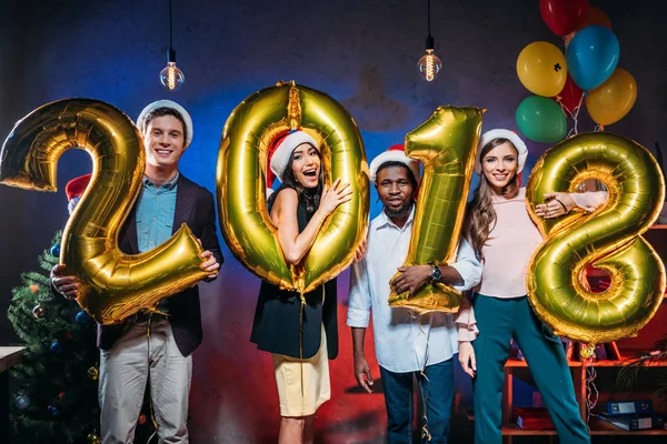 Young friends with golden balloons — Stock Photo, Image