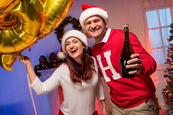 Couple with balloons and champagne bottle — Stock Photo, Image