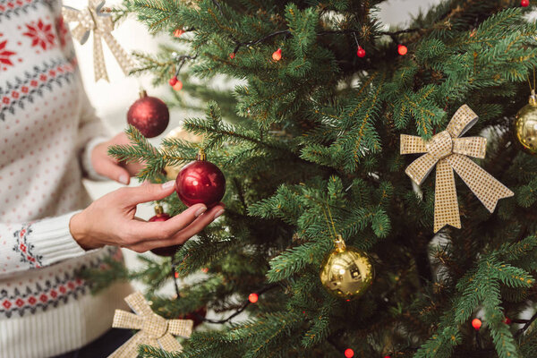 girl decorating christmas tree